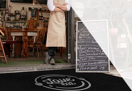 Why is it important for stores to invest in entrance mats?
